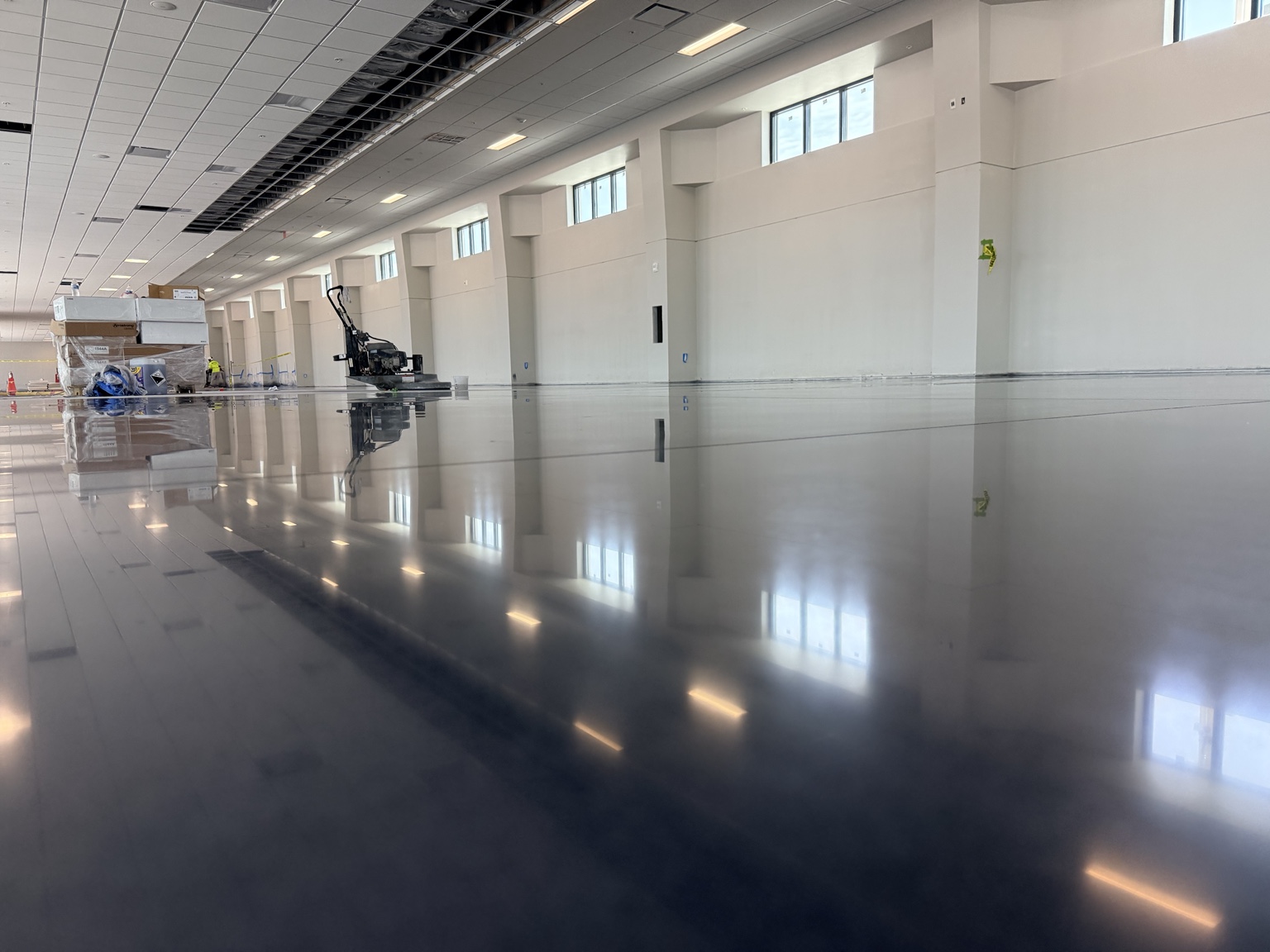 Polished commercial floor reflecting overhead windows